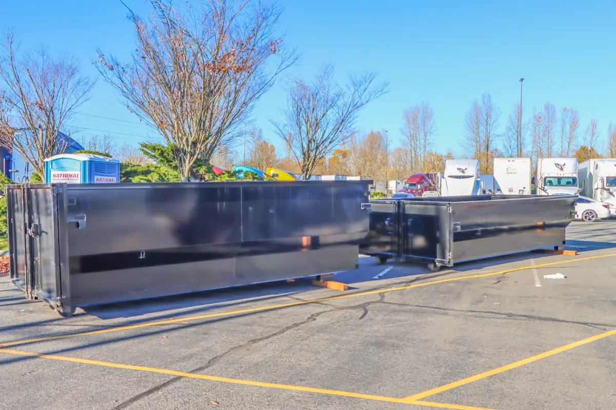 Professional dumpster rental service with roll-off container on residential driveway in Green Hill